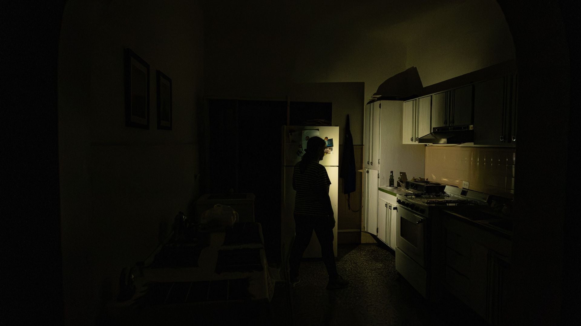 Una mujer caminando en su casa durante un corte eléctrico, en Maracaibo (Venezuela)-Foto: EFE